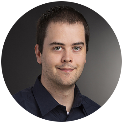 Garreth smiling toward the camera wearing a dark blue shirt.